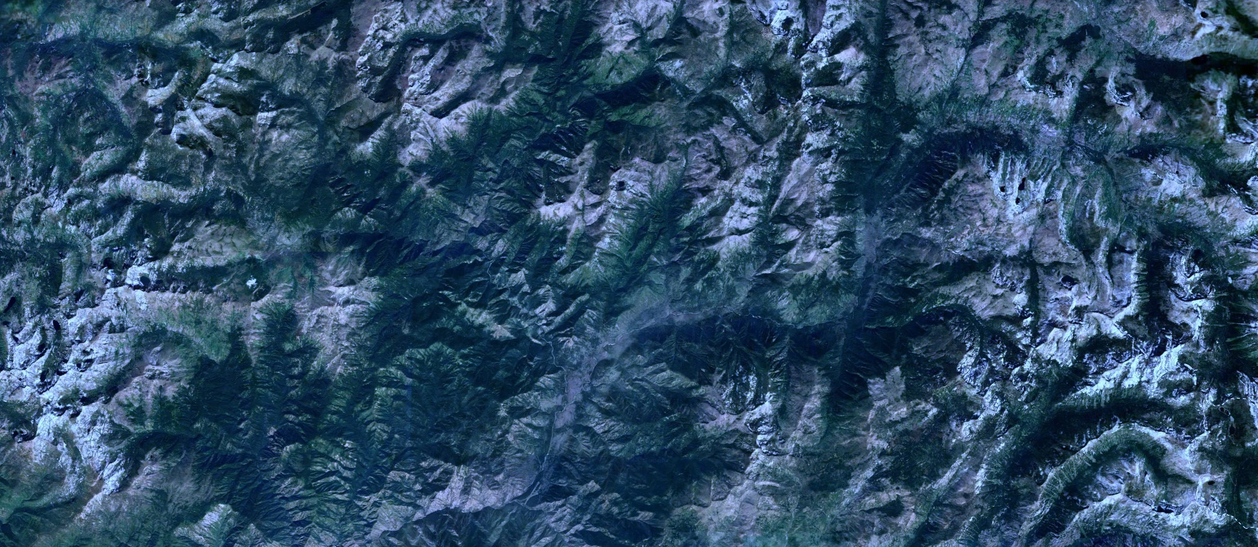 Cold mountain landscape with illuminated infrastructure signals.